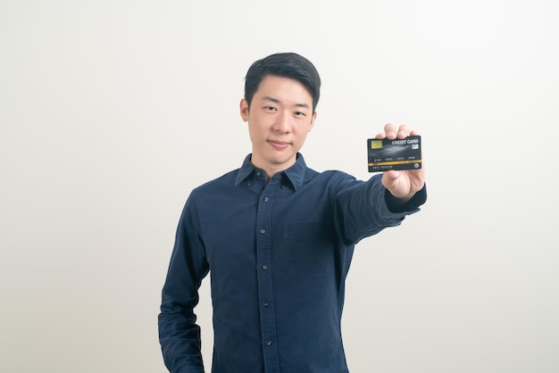 Young Asian man holding credit card