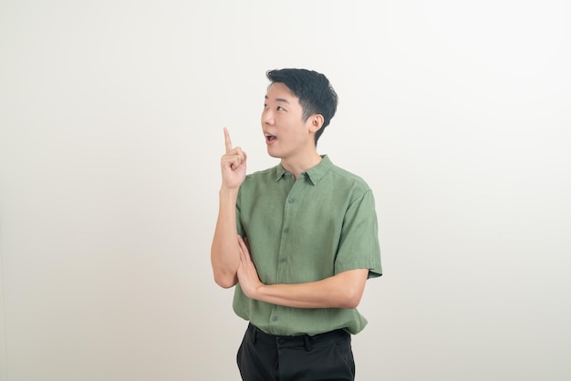 Young Asian man thinking on white background