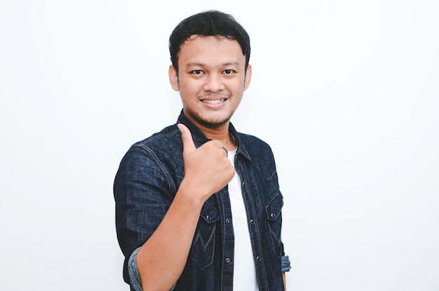 Young Asian man wear white shirt with happy smiling face and thumbs up