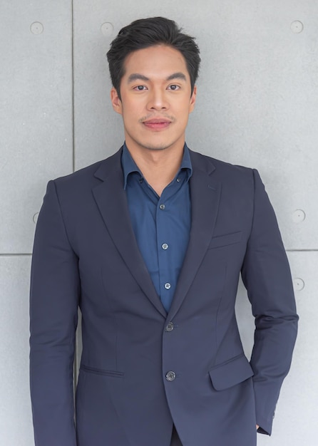 Young Asian man wearing a suit to work office worker looks friendly