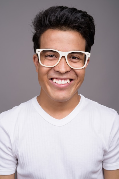 young Asian man wearing white shirt and eyeglasses 