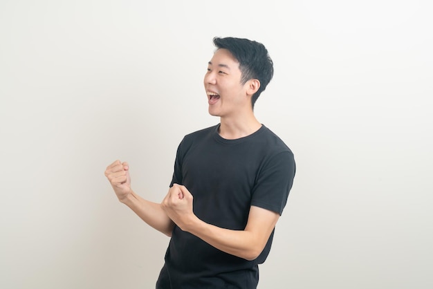 young Asian man with successful action on white background