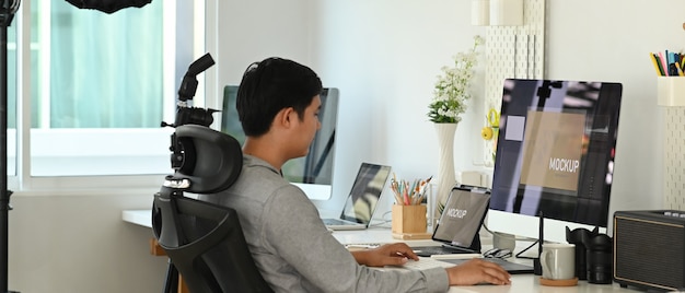 Young Asian man working from home on a computer