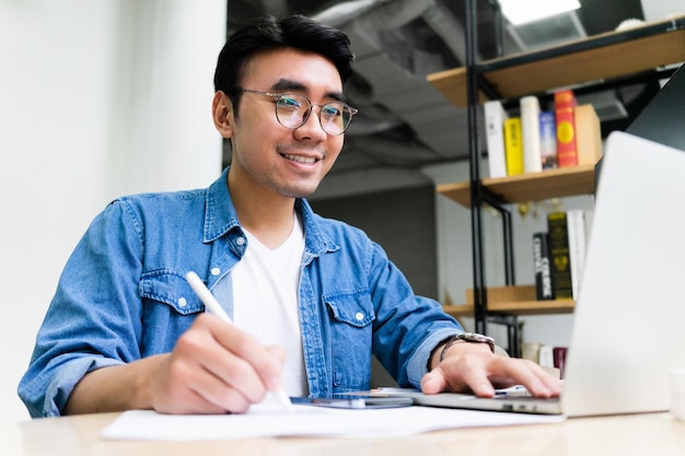 Young Asian man working at office