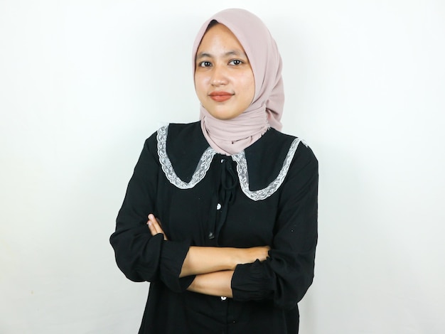 Young asian muslim woman in head scarf smile with arms crossed