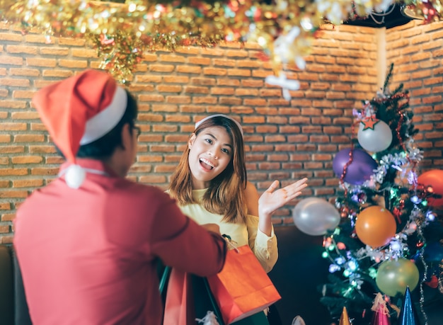 Young Asian people are happy to receive gifts on Christmas Eve.