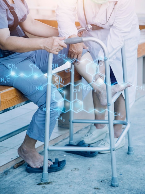 Young asian physical therapist working with senior woman on walking with a walker