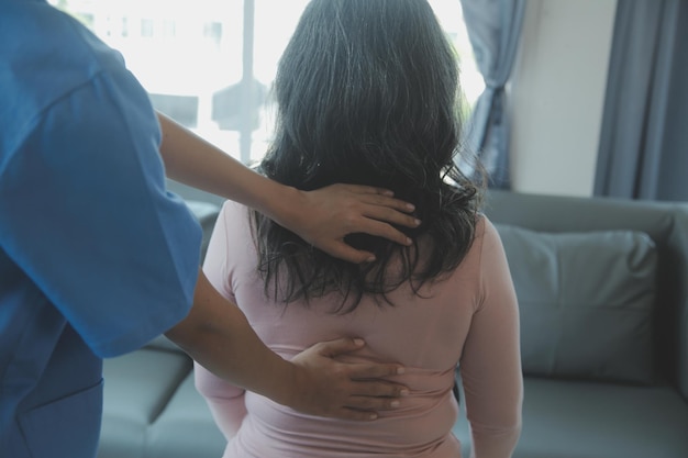 Young asian physical therapist working with senior woman on walking with a walker