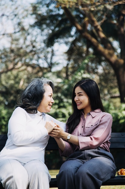 Young asian physical therapist working with senior woman on walking with a walker