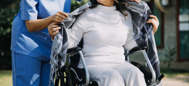 Young asian physical therapist working with senior woman on walking with a walker