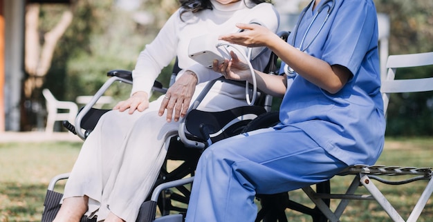 Young asian physical therapist working with senior woman on walking with a walker