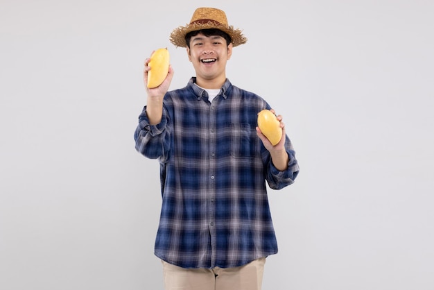 Young Asian smart farmer shows organic yellow mango fruit on white background