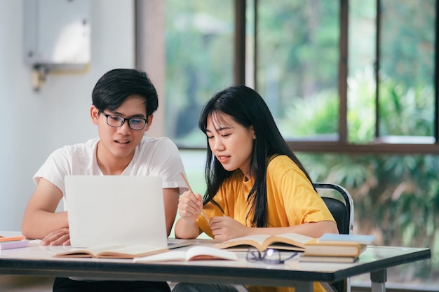 Young asian students campus helps friend catching up and learning