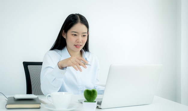 Young Asian teachers are teaching fun online from their home office, social distancing teaching concept during COVID virus diseases.