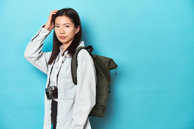 Young Asian traveler ready to capture adventures being shocked she has remembered important meeting