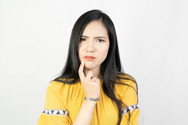 young asian woman doing a thinking pose on white .