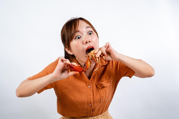 young asian woman enjoys eating seafood crab with padang sauce