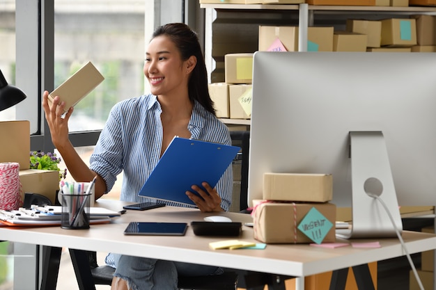 Young Asian woman entrepreneur Business owner working  at home  for online shopping