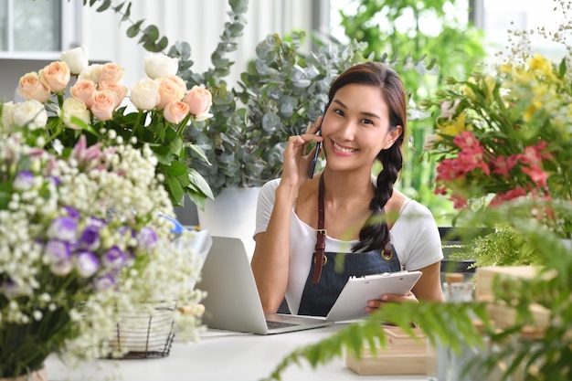 Young Asian woman entrepreneur/shop owner/ florist of a small flower shop business