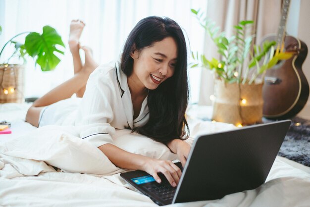 Young Asian woman freelance working business work on laptop at home, working from home concept