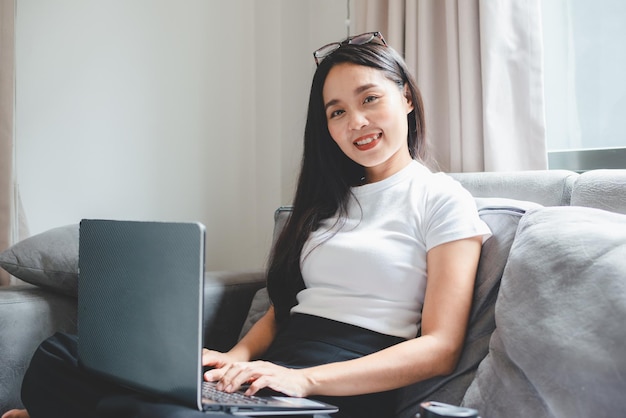 Young Asian woman freelance working business work on laptop at home working from home concept