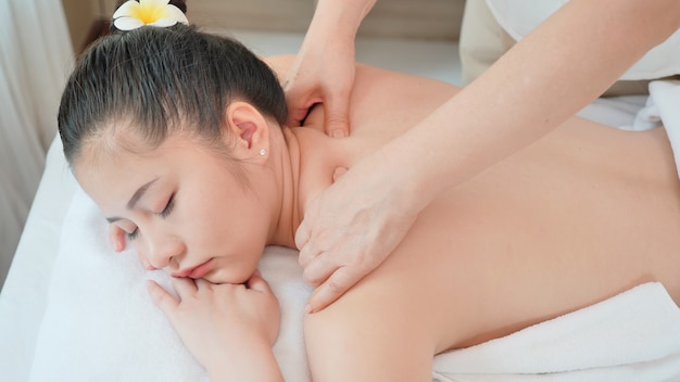 Young Asian woman getting Relaxing oil massage at beauty spa salon. Massage for health