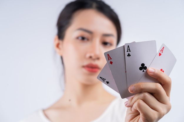 Young Asian woman holding poker card on hand