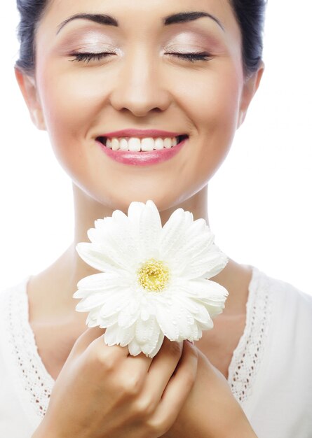 Young asian woman holding white gerber flower