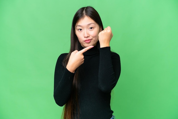 Young Asian woman over isolated chroma key background making the gesture of being late