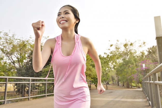 Young asian woman jogging on the park