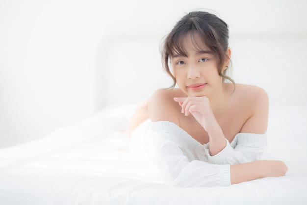 Young Asian woman lying and smile while waking up