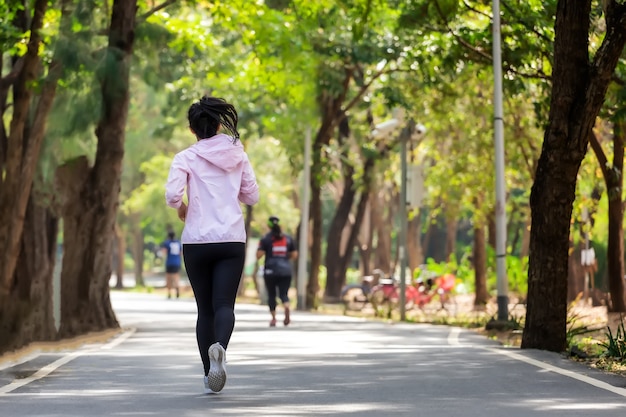 Young asian woman runing in park on street in sportswear.