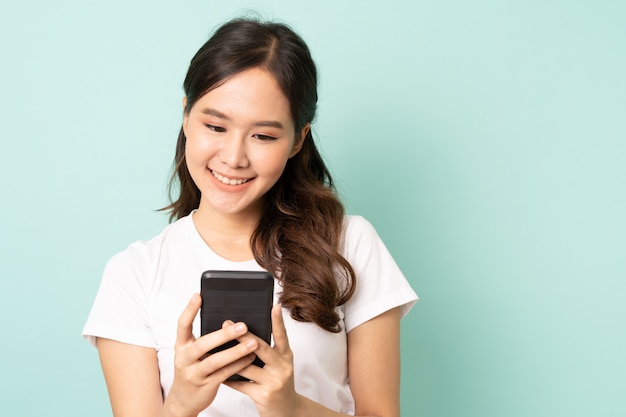 Young asian woman smiling on blue background