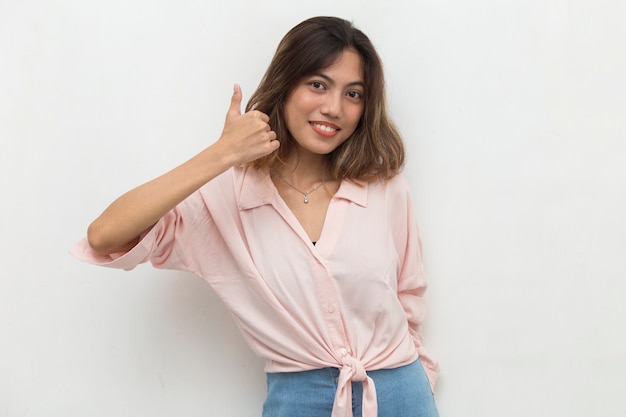 Young asian woman smiling and making OK sign with hand gesture