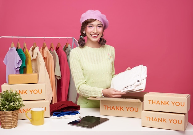 Young asian woman startup small business freelance seller clothing with parcel box and tablet