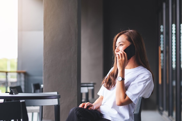 A young asian woman talking on mobile phone