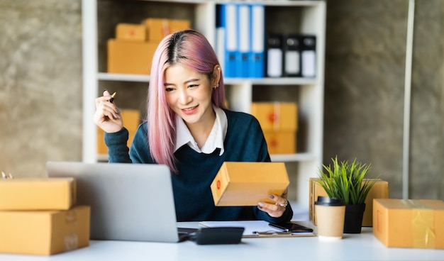 Young asian Woman Thinking and Working on sell online in cozy house Modern Lifestyle of New Generation People