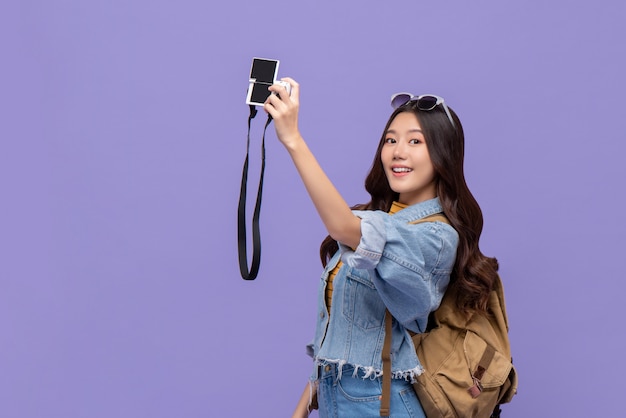 Young Asian woman tourist taking selfie with camaera