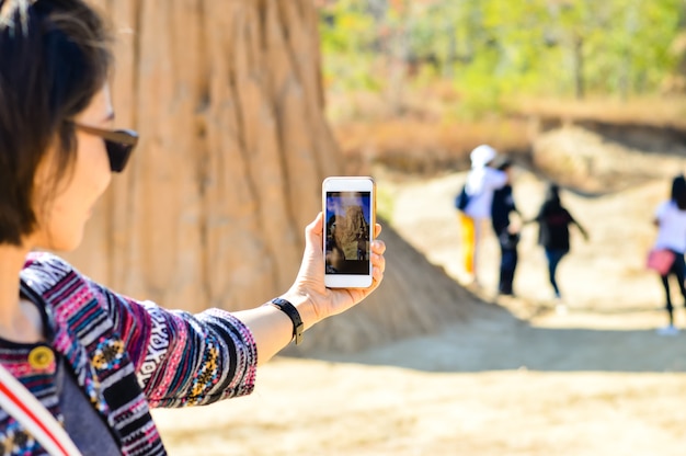 Young asian woman Use smart phone to take photo on vacation.