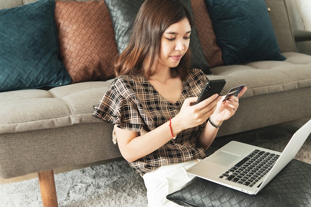 Young Asian woman using credit card for online shopping