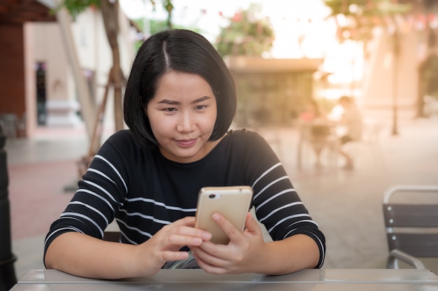 Young Asian woman using mobile phone