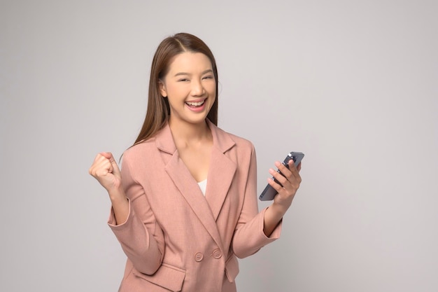 Young asian woman using smartphone over white background technology concept x9x9