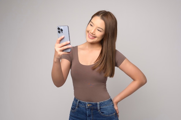 Young asian woman using smartphone over white background technology concept x9x9