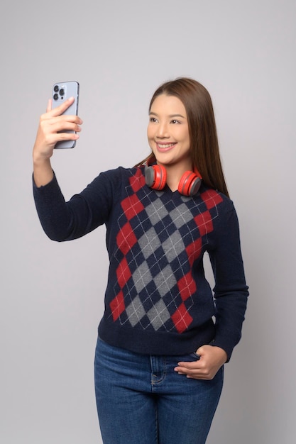 Young asian woman using smartphone over white background technology concept x9x9