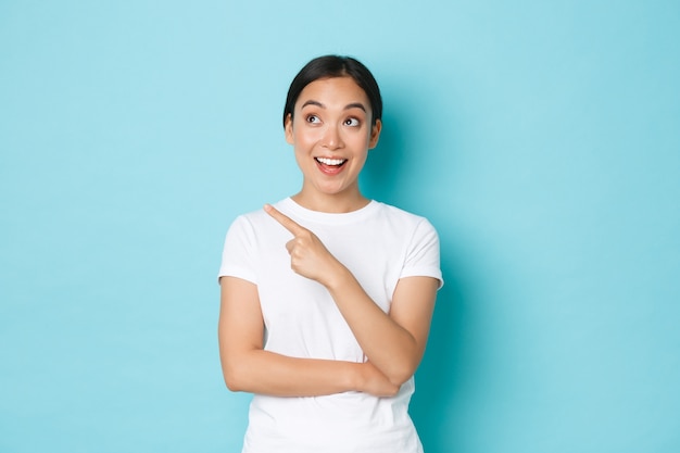 Young Asian woman wearing casual T-shirt posing