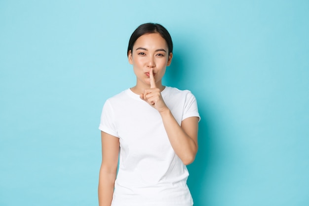 Young Asian woman wearing casual T-shirt posing