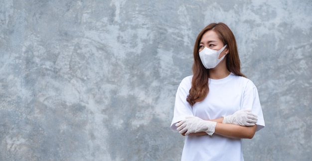 A young asian woman wearing protective face mask and medical rubber gloves for Health care and Covid19 concept