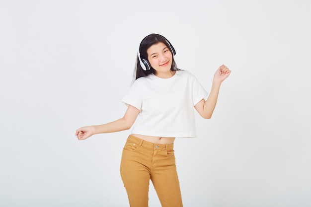 Young Asian woman with headphones dancing