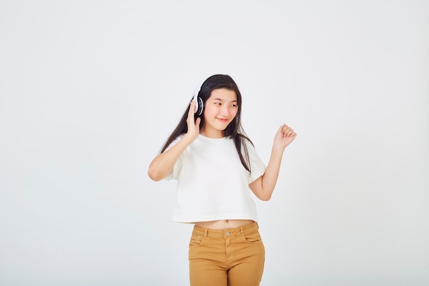 Young Asian woman with headphones dancing