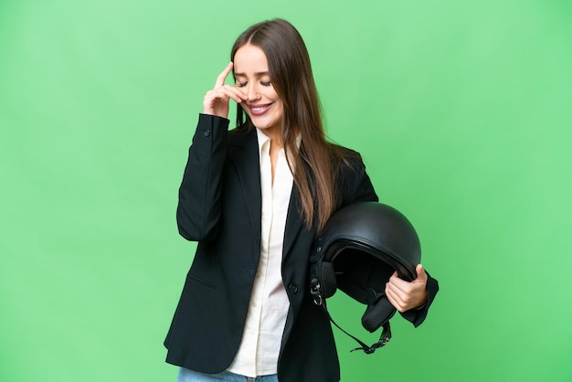 Young Asian woman with a motorcycle helmet over isolated chroma key background laughing